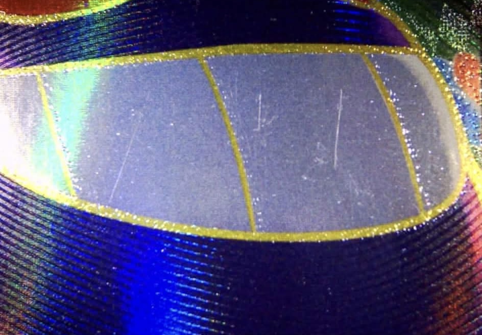 Pokemon card before restoration - visible scratches on holo surface